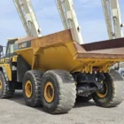 Komatsu HM400-3R articulated dump truck rear side view showing dump body and axle area