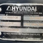 Hyundai excavator identification plate showing model R210-7, serial number and operating weight